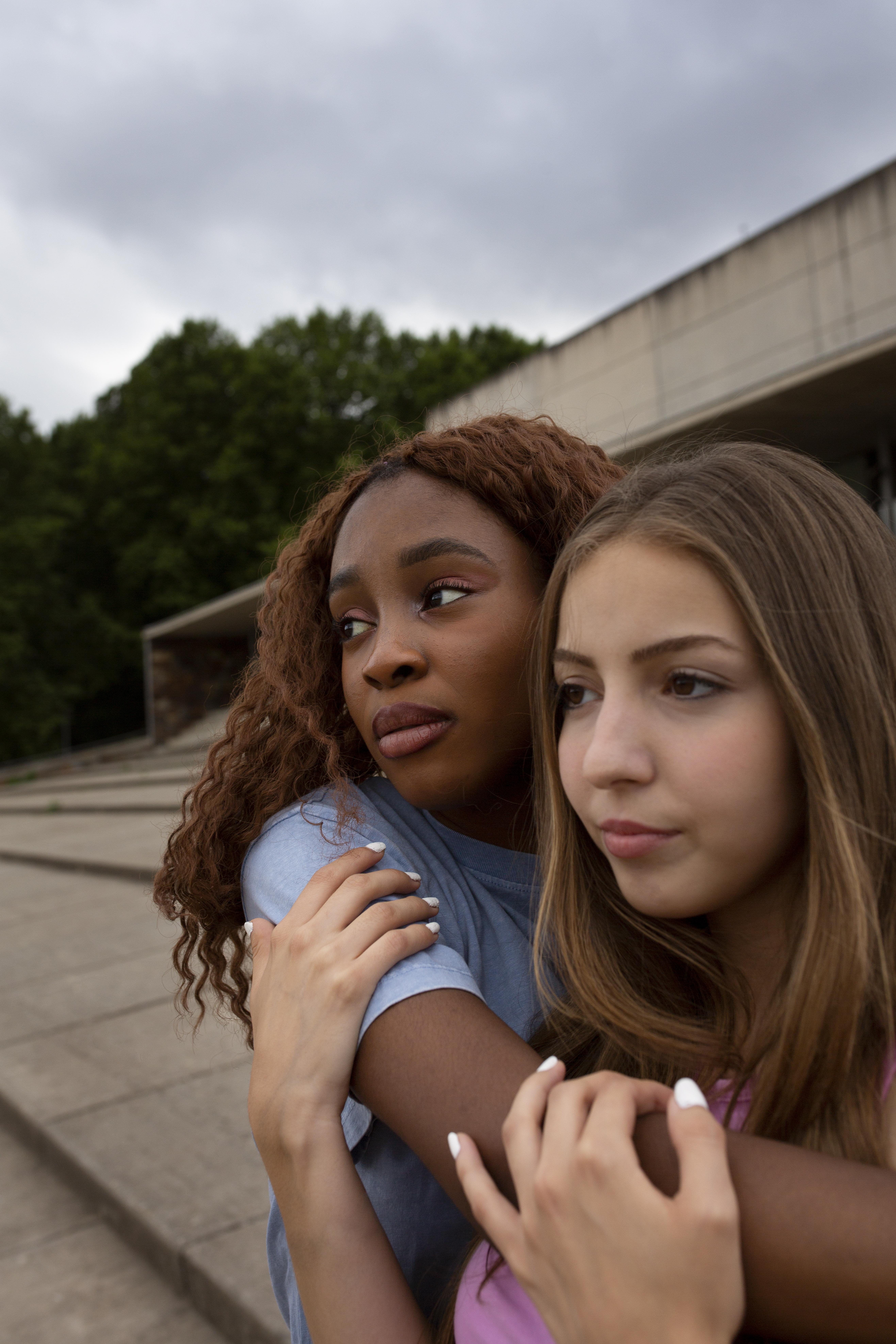 two-teenage-girls-posing-together-while-spending-time-outdoors