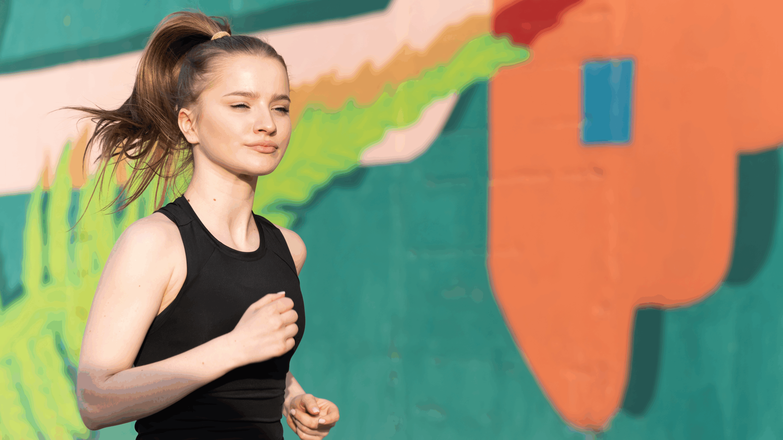 young-blonde-woman-sportswear-running-road-outdoors-training-multicolored-wall-background